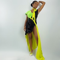 a woman in a yellow and black dress posing for a photo