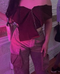 a woman is posing with a bottle of wine