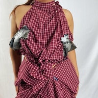 a woman wearing a burgundy checkered dress