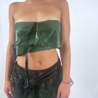 a woman wearing a green strapless top and black tutu