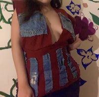 a woman posing in front of a wall