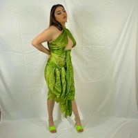 a woman in a green dress posing for a photo